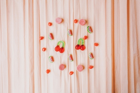 Fruits jelly beans over a salmon colored paper background