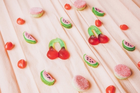 Fruits jelly beans over a salmon colored paper background