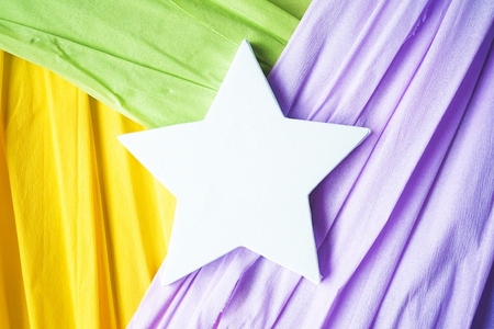 Mockup of a white star canvas over colorful paper background