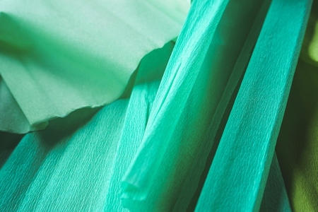 Green textured image of crepe paper in green tones