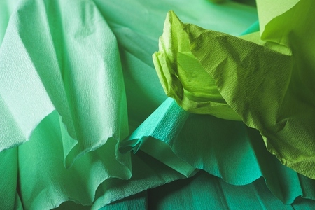 Green textured image of crepe paper in green tones