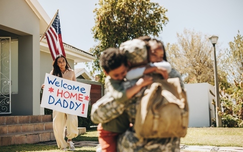 Soldier receiving a warm welcome from his family