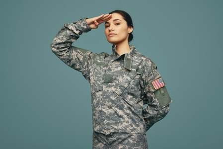 United States servicewoman saluting in a studio