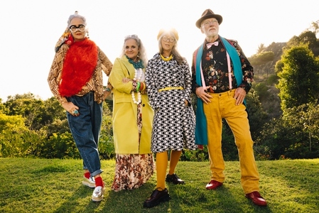 Four senior friends wearing colourful clothing in a park