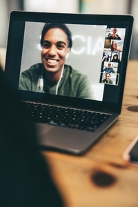 Anonymous entrepreneur attending a virtual meeting in an office