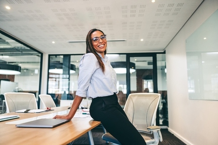 Businesswoman smiling cheerfully in a boardroom