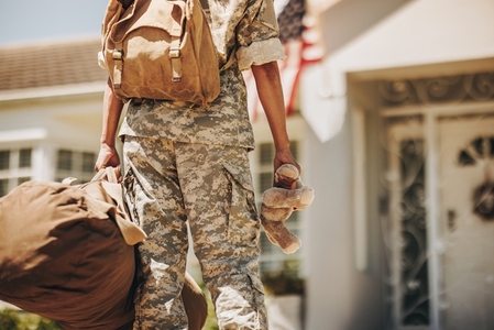 Rearview of a military mom returning home from the army