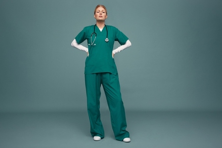 Confident female doctor standing in a studio