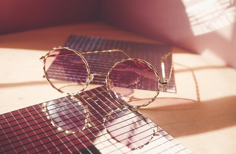 Studio shot of trendy female sunglasses in coral tones for summe