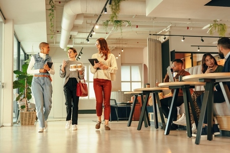 Group of businesswomen walking through a modern office