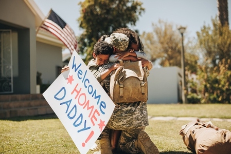 Serviceman reuniting with his family after returning home