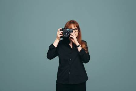 Professional photographer taking a picture in a studio
