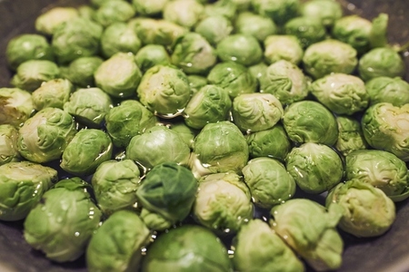 Close up green Brussels sprouts soaking in water