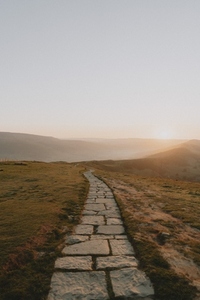 Stone walkway in tranquil remote landscape at sunrise