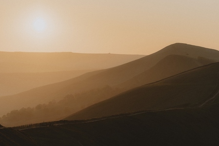 Silhouetted hills in golden sunrise landscape