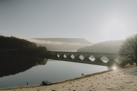 Bridge over river in tranquil frosty morning landscape