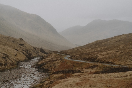 Road along stream in remote landscape