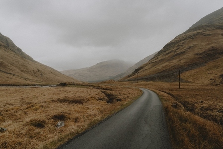 Cracked road through landscape in tranquil Scottish Highlands