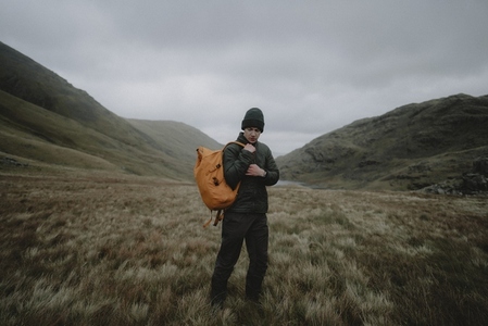 Male hiker with backpack in remote landscape