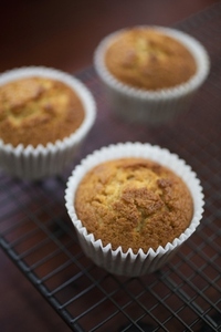Close up corn muffins in cupcake liners on cooling rack