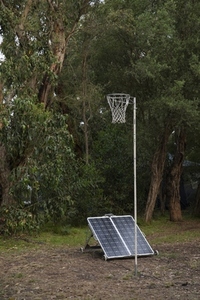 Solar panels below basketball hoop among trees