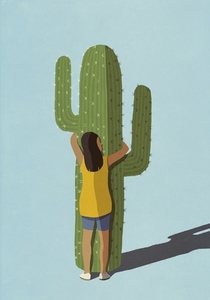 Woman hugging spiky cactus