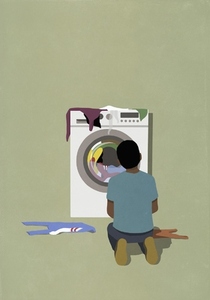 Man kneeling at dryer waiting for laundry to dry