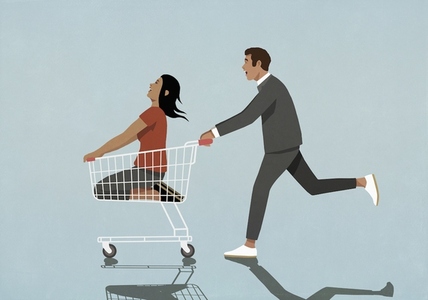 Man pushing happy carefree woman in shopping cart