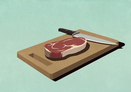 Raw steak on cutting board with knife