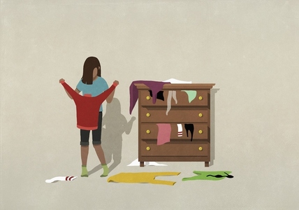 Girl holding sweater at messy bedroom dresser