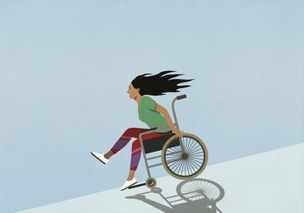 Carefree woman speeding downhill in wheelchair