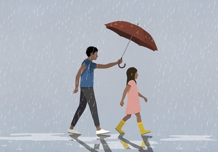 Father holding umbrella over daughter walking in rain