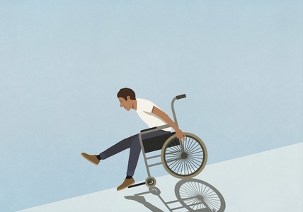 Carefree man speeding downhill in wheelchair