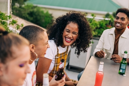 Happy young woman laughing with her friends
