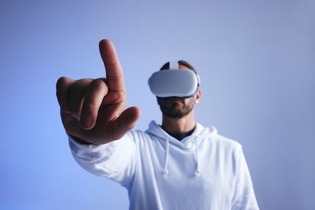 Young man touching a button in virtual space