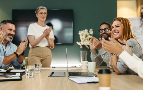 Successful businesspeople applauding during a meeting