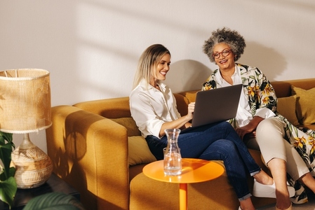 Cheerful businesswomen working together on a couch