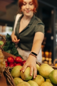 Female customer buying fruits and vegetables in a grocery store