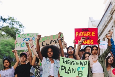 Diverse young people standing up against global warming
