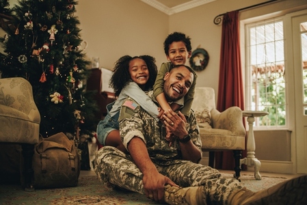 Happy military dad spending Christmas with his children