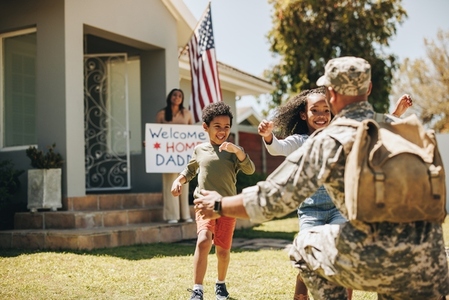 American soldier reuniting with his family at home