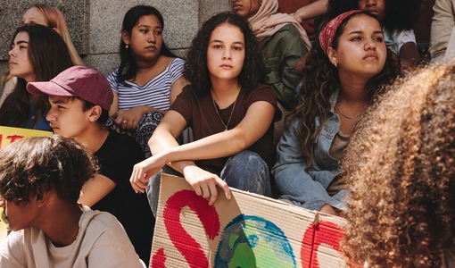 Diverse youth activists holding a climate change demonstration
