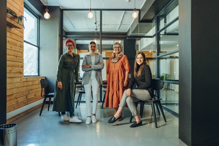 Successful businesswomen smiling at the camera in an office