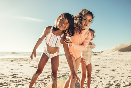 Group of young girls playing together at the beach