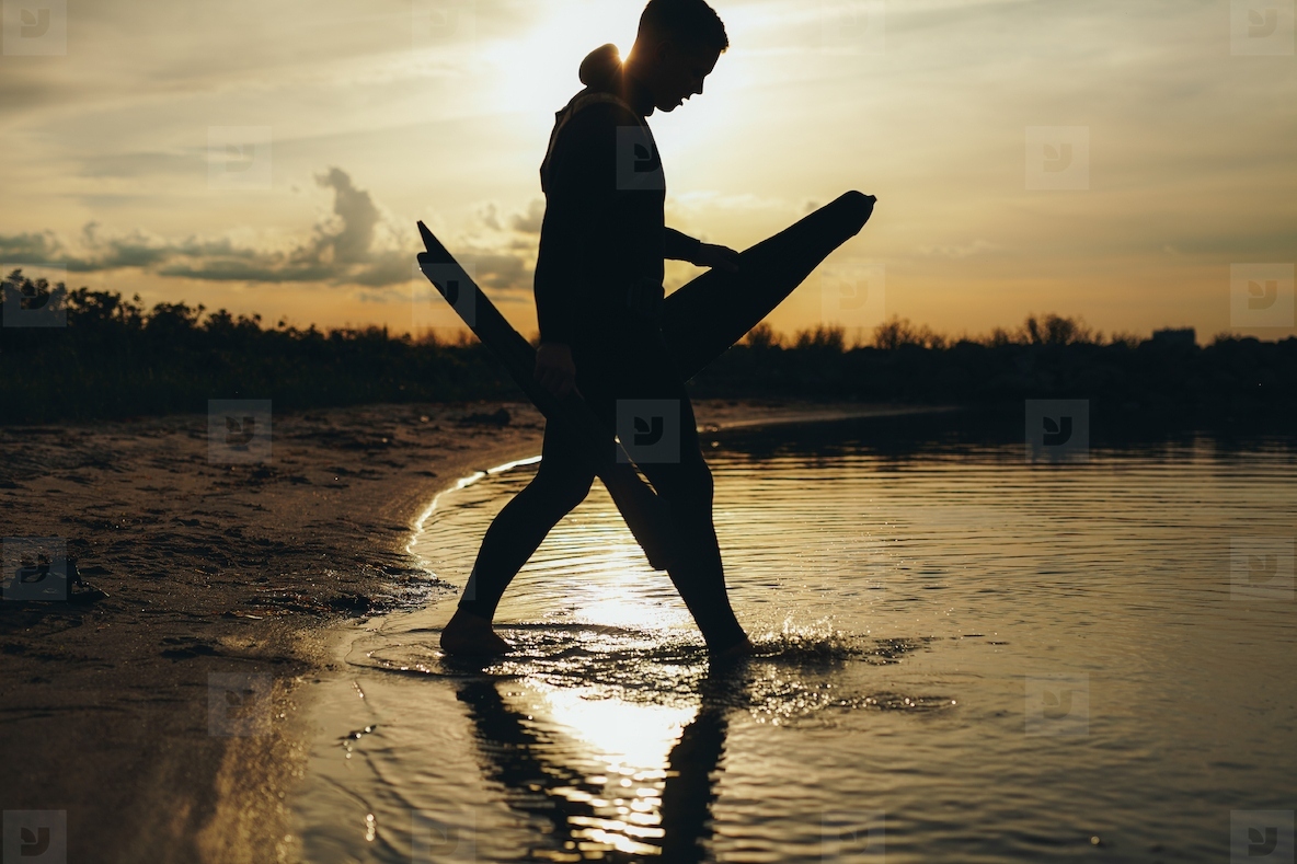 Young man going spearfishing at sunset