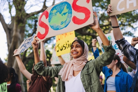 Diverse young people standing up for the earth
