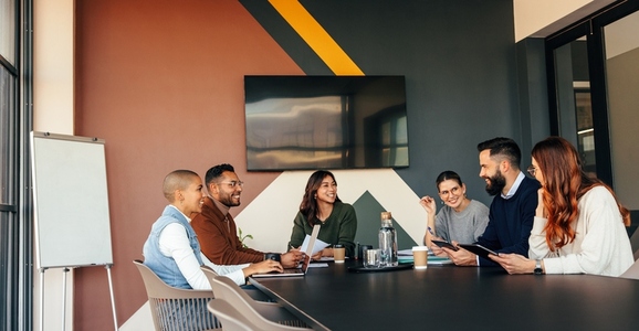 Happy businesspeople having a meeting in a boardroom
