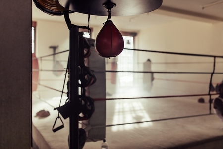 Empty boxing ring with a speed bag in the foreground