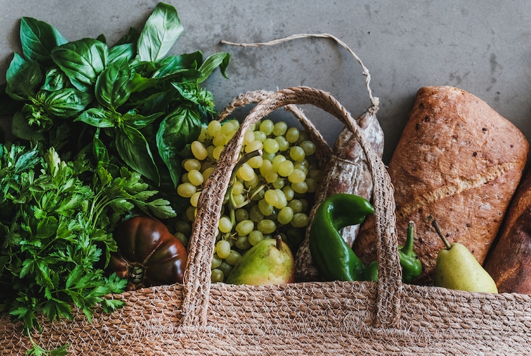 Flat-lay of healthy shopping bag with fresh produce, wide composition