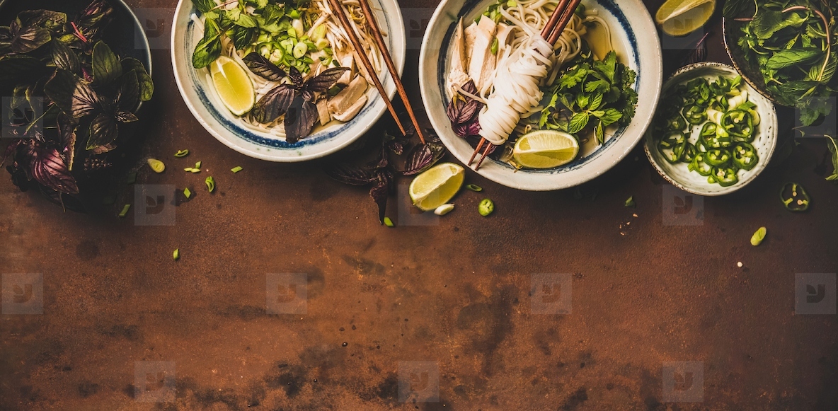 Flat lay of Vietnamese lunch with soup Pho Ga  wide composition